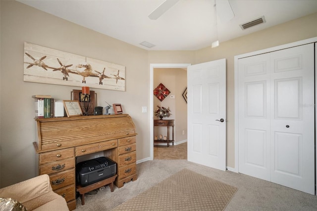 121 Colonial St SW, Port Charlotte, FL 33952 - sitting room with carpet flooring, a ceiling fan, baseboards, and visible vents