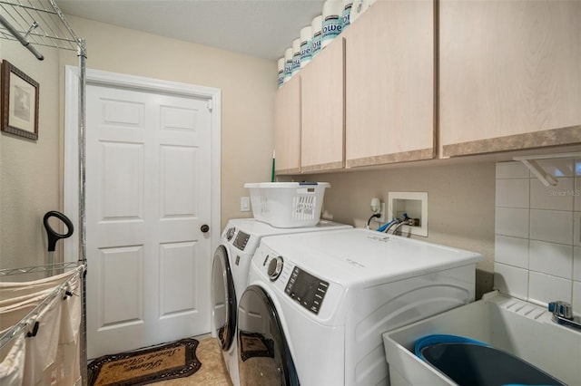 121 Colonial St SW, Port Charlotte, FL 33952 - washroom featuring a sink, cabinet space, and washer and clothes dryer