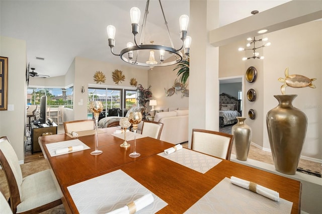 121 Colonial St SW, Port Charlotte, FL 33952 - dining room with ceiling fan with notable chandelier, a towering ceiling, and baseboards