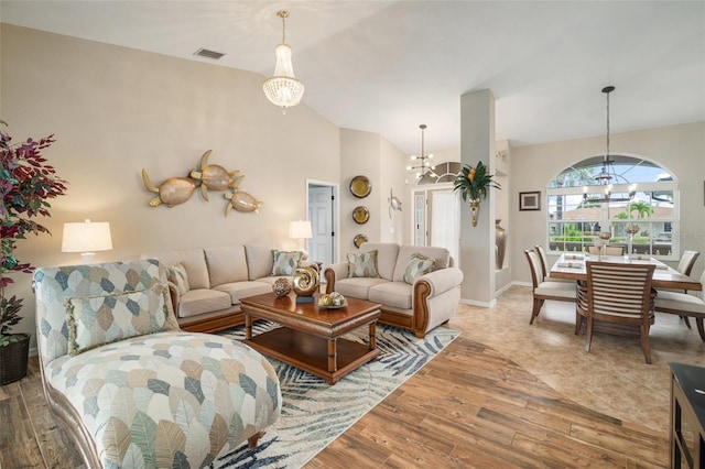 121 Colonial St SW, Port Charlotte, FL 33952 - living room with wood finished floors, vaulted ceiling, a chandelier, and visible vents