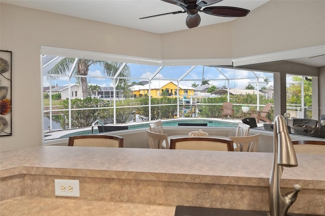 121 Colonial St SW, Port Charlotte, FL 33952 - view of patio with glass enclosure, outdoor dining area, a ceiling fan, and an outdoor pool
