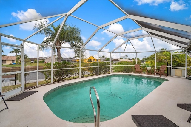 121 Colonial St SW, Port Charlotte, FL 33952 - outdoor pool featuring glass enclosure and a patio