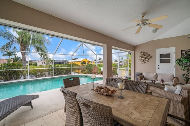 121 Colonial St SW, Port Charlotte, FL 33952 - outdoor pool with outdoor lounge area, glass enclosure, a patio, and a ceiling fan