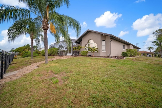 121 Colonial St SW, Port Charlotte, FL 33952 - view of yard featuring glass enclosure and fence