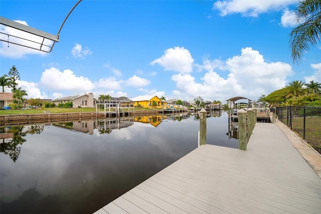 121 Colonial St SW, Port Charlotte, FL 33952 - view of dock with a water view, fence, and a residential view