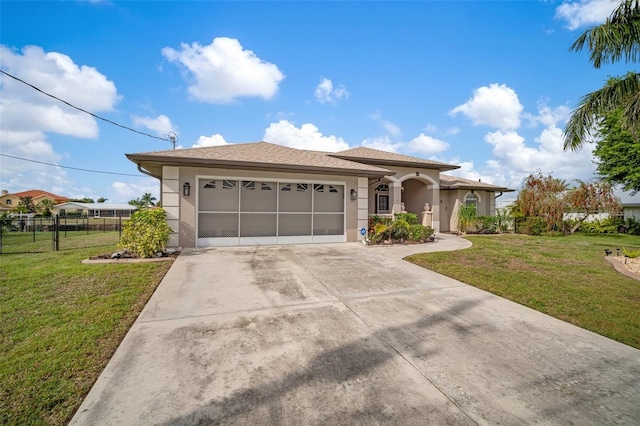 121 Colonial St SW, Port Charlotte, FL 33952 - view of front of house featuring a front yard, stucco siding, fence, and a garage