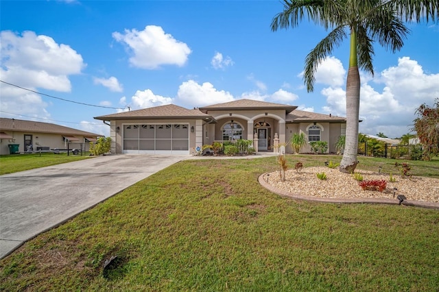 121 Colonial St SW, Port Charlotte, FL 33952 - mediterranean / spanish-style home with a front yard, concrete driveway, stucco siding, and an attached garage