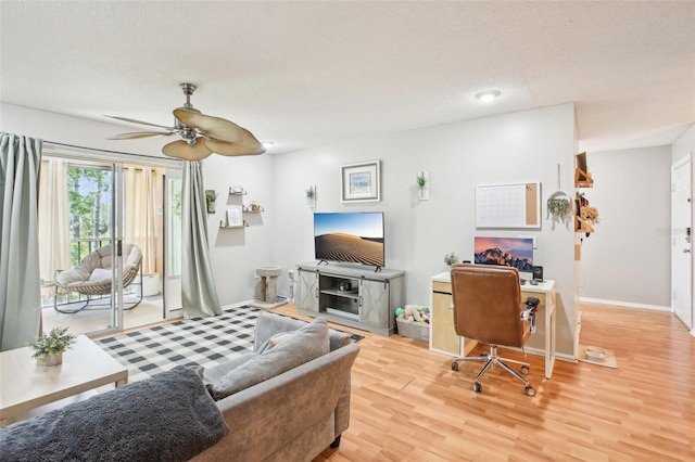 9481 Highland Oak Dr Unit 1616, Tampa, FL 33647 - living area featuring wood finished floors, a ceiling fan, baseboards, and a textured ceiling