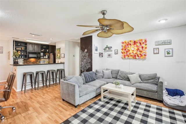 9481 Highland Oak Dr Unit 1616, Tampa, FL 33647 - living area with light wood-type flooring, a textured ceiling, ceiling fan, and recessed lighting