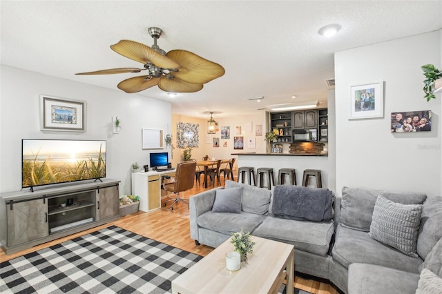 9481 Highland Oak Dr Unit 1616, Tampa, FL 33647 - living room featuring light wood finished floors, a ceiling fan, and recessed lighting
