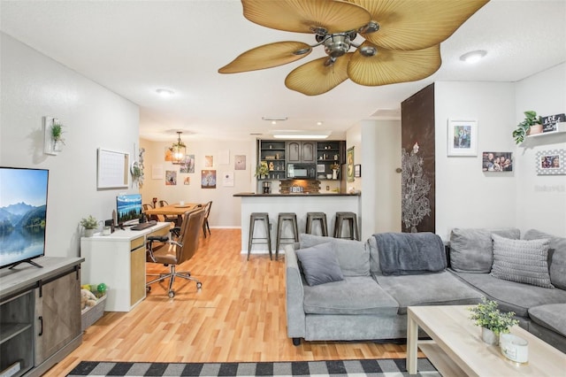 9481 Highland Oak Dr Unit 1616, Tampa, FL 33647 - living area featuring light wood-type flooring, a chandelier, and ceiling fan