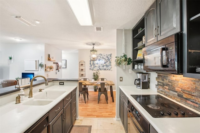 9481 Highland Oak Dr Unit 1616, Tampa, FL 33647 - kitchen with black appliances, open shelves, a sink, light countertops, and baseboards