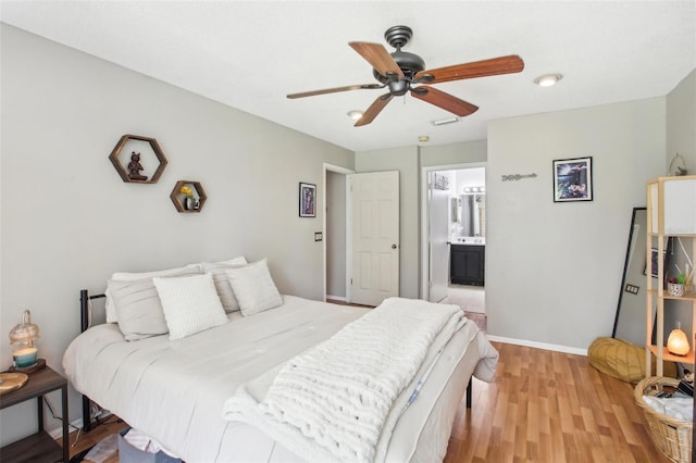 9481 Highland Oak Dr Unit 1616, Tampa, FL 33647 - bedroom with light wood-style flooring, ensuite bath, baseboards, and ceiling fan