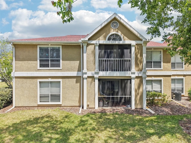 9481 Highland Oak Dr Unit 1616, Tampa, FL 33647 - back of house with stucco siding, a lawn, and cooling unit