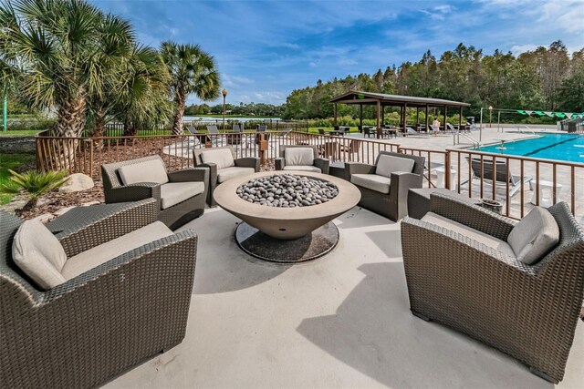 9481 Highland Oak Dr Unit 1616, Tampa, FL 33647 - view of patio with an outdoor living space with a fire pit, a gazebo, and a community pool
