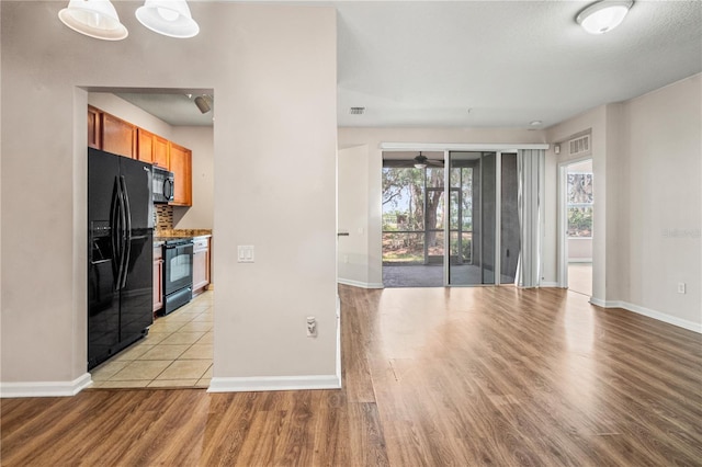2009 River Turia Cir, Riverview, FL 33578 - interior space with light wood-style floors, baseboards, ceiling fan, and visible vents