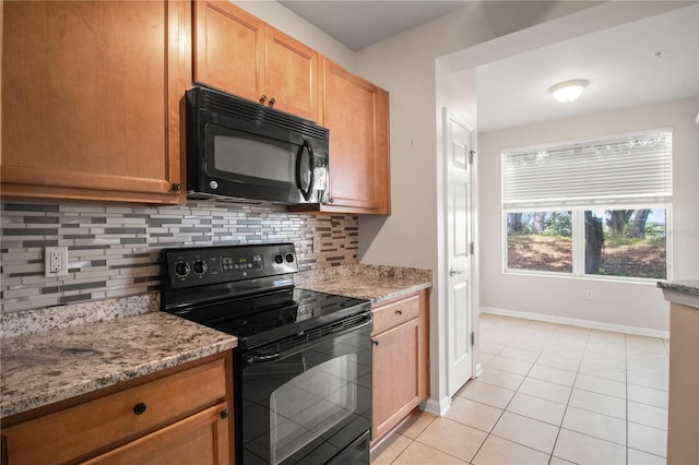 2009 River Turia Cir, Riverview, FL 33578 - kitchen featuring light tile patterned flooring, baseboards, light stone counters, backsplash, and black appliances