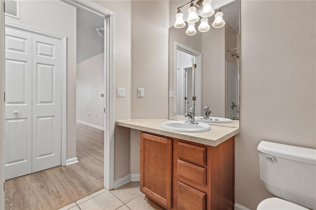 2009 River Turia Cir, Riverview, FL 33578 - bathroom featuring visible vents, vanity, tile patterned floors, toilet, and an inviting chandelier