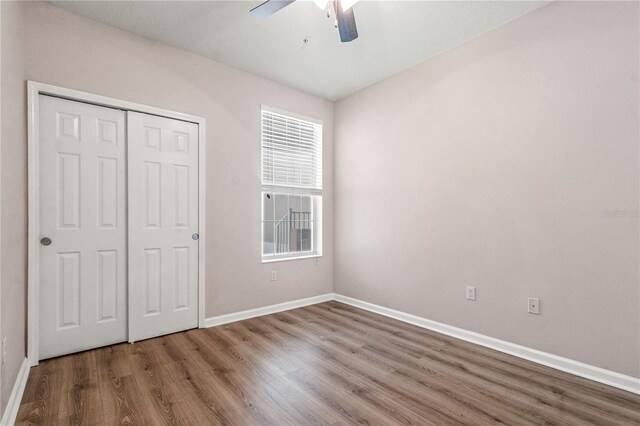 2009 River Turia Cir, Riverview, FL 33578 - unfurnished bedroom with baseboards, a ceiling fan, wood finished floors, and a closet
