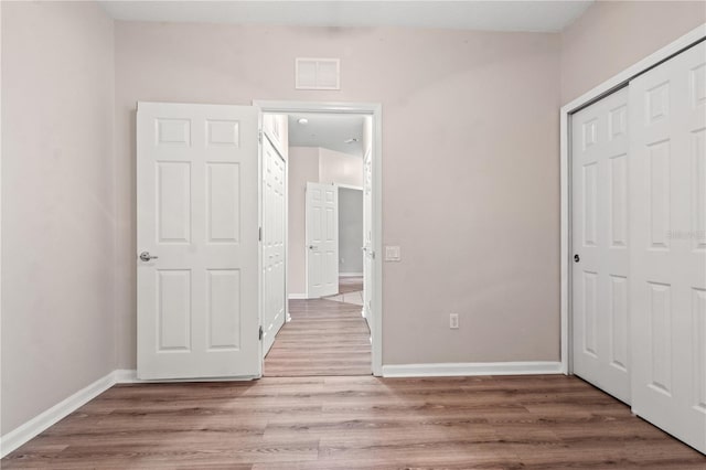 2009 River Turia Cir, Riverview, FL 33578 - unfurnished bedroom with a closet, baseboards, visible vents, and light wood-style floors