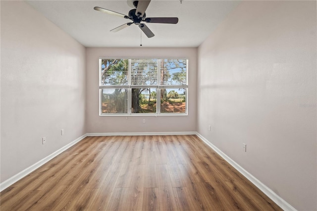2009 River Turia Cir, Riverview, FL 33578 - spare room with baseboards, a ceiling fan, and wood finished floors