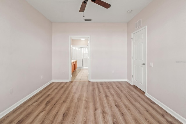 2009 River Turia Cir, Riverview, FL 33578 - unfurnished bedroom featuring ceiling fan, light wood finished floors, ensuite bath, baseboards, and visible vents