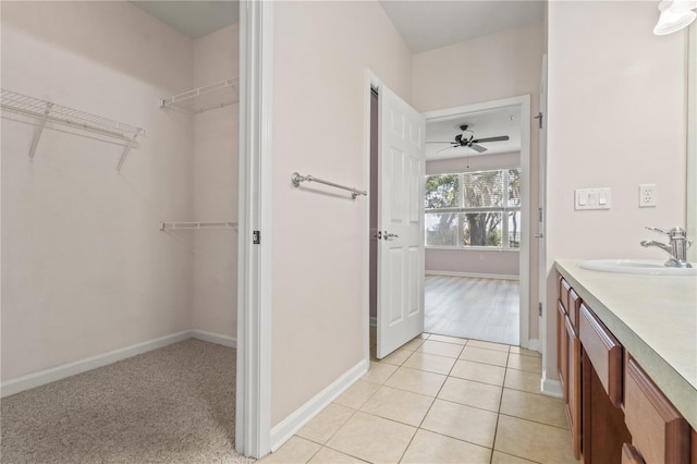 2009 River Turia Cir, Riverview, FL 33578 - bathroom with baseboards, a spacious closet, tile patterned flooring, and vanity