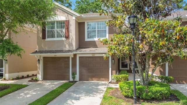 2009 River Turia Cir, Riverview, FL 33578 - view of front of property featuring a garage, stucco siding, and driveway