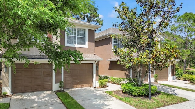 2009 River Turia Cir, Riverview, FL 33578 - view of front facade featuring a garage, stucco siding, and concrete driveway