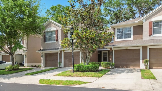 2009 River Turia Cir, Riverview, FL 33578 - townhome / multi-family property featuring an attached garage, driveway, and stucco siding