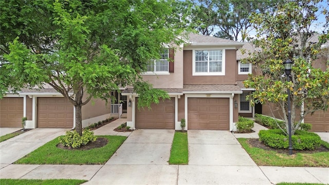2009 River Turia Cir, Riverview, FL 33578 - view of front of home with a garage, stucco siding, and driveway