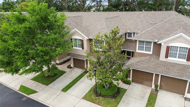 2009 River Turia Cir, Riverview, FL 33578 - view of front of home with a garage, roof with shingles, stucco siding, and driveway