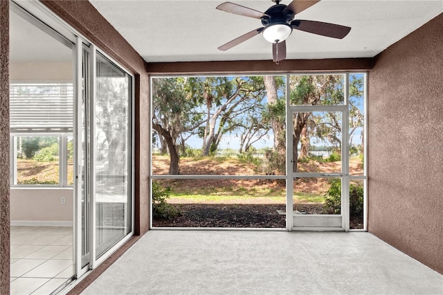 2009 River Turia Cir, Riverview, FL 33578 - unfurnished sunroom featuring ceiling fan, a textured wall, and tile patterned floors