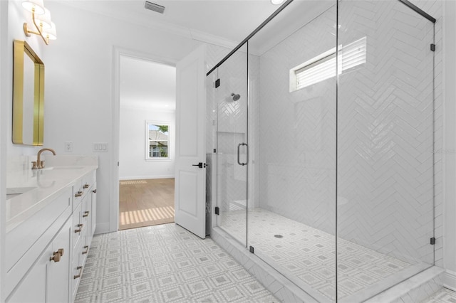 bathroom with vanity, a shower stall, and baseboards