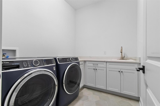 laundry room with separate washer and dryer, cabinet space, and light tile patterned flooring