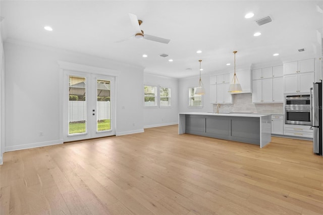 kitchen with a ceiling fan, white cabinets, baseboards, recessed lighting, and tasteful backsplash