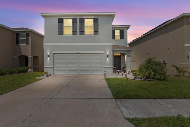 10937 Penny Gale Loop, San Antonio, FL 33576 - traditional-style house with stucco siding, driveway, a front yard, and an attached garage