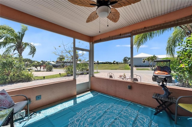 sunroom with a healthy amount of sunlight and a ceiling fan