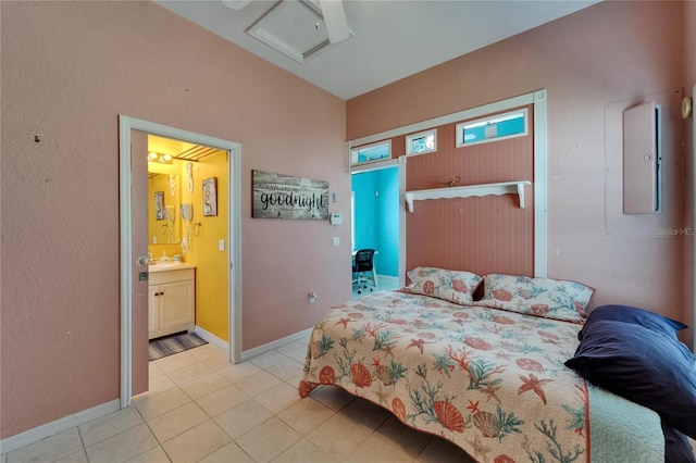 bedroom featuring attic access, baseboards, and light tile patterned floors