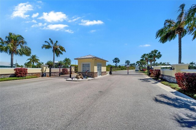 view of street featuring a gated entry and a gate