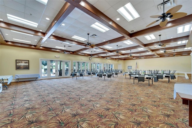 interior space with beamed ceiling, carpet flooring, ceiling fan, and coffered ceiling