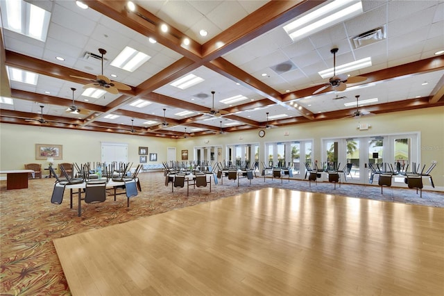 miscellaneous room with carpet flooring, beam ceiling, visible vents, baseboards, and a ceiling fan