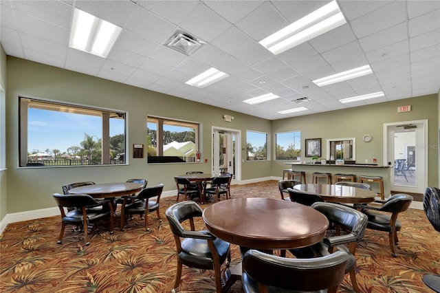 dining room featuring baseboards, a paneled ceiling, and visible vents