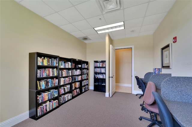 office space with baseboards, carpet, and a drop ceiling