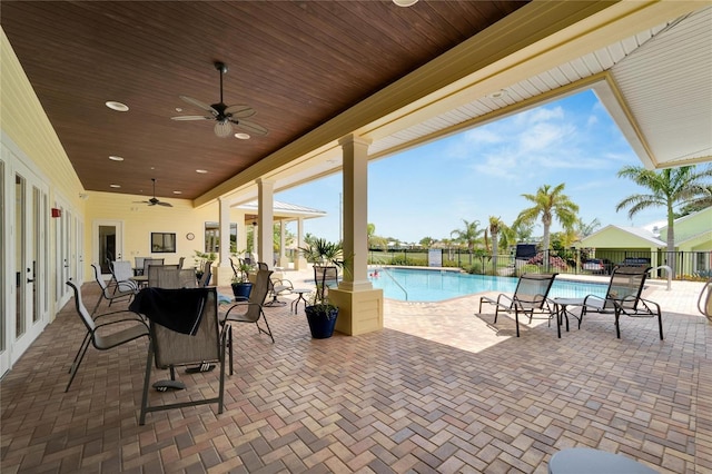 view of patio / terrace with ceiling fan, a fenced in pool, and fence