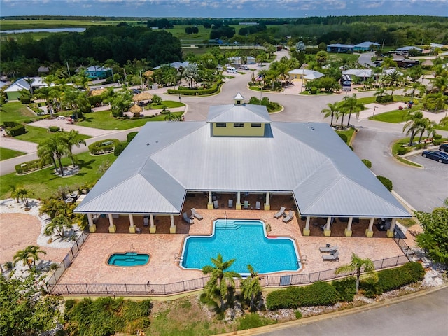 community pool with fence and a patio