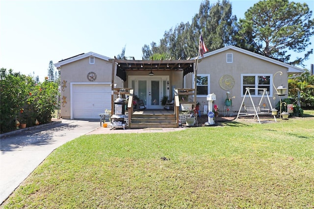 2132 40th Ave N, Saint Petersburg, FL 33714 - view of front of home with french doors, an attached garage, stucco siding, and concrete driveway
