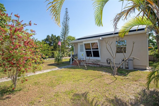 2132 40th Ave N, Saint Petersburg, FL 33714 - view of front of property with a front yard, stucco siding, and solar panels