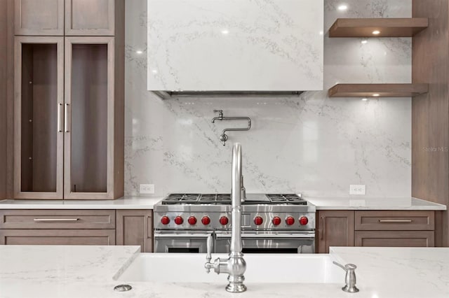 3406 W Alline Ave, Tampa, FL 33611 - kitchen with backsplash, double oven range, and light stone counters