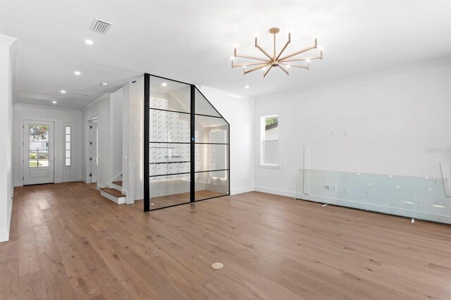 3406 W Alline Ave, Tampa, FL 33611 - spare room featuring a chandelier, stairs, wood finished floors, recessed lighting, and baseboards
